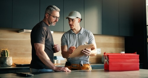 A plumber consults with a homeowner.