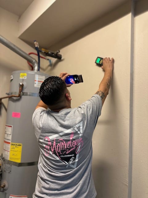 A Marvelous plumber uses a camera to inspect a wall