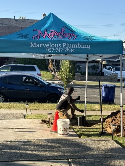 A Marvelous plumber works on an outdoor sewer cleaning